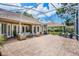 Enjoy outdoor living on this covered patio with stone flooring and comfortable seating at 174 Promenade Cir, Lake Mary, FL 32746
