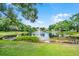 A tranquil pond in a verdant backyard setting enhances the property's appeal at 174 Promenade Cir, Lake Mary, FL 32746