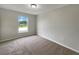 Bright bedroom with a large window, plush carpeting, and ample natural light creating a cozy retreat at 1793 Western Hills Ln # N, Mascotte, FL 34753