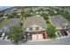 Aerial view of townhomes with maintained lawns, mature trees, and a view of the community at 1984 Estancia Circle # 29A, Kissimmee, FL 34741