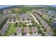 An aerial view shows homes nestled by ponds, and verdant greenery at 1984 Estancia Circle # 29A, Kissimmee, FL 34741