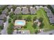 Aerial view highlighting community pool and playground, surrounded by well-maintained landscaping at 1984 Estancia Circle # 29A, Kissimmee, FL 34741