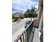 View from the balcony overlooking a quiet street with trees at 1984 Estancia Circle # 29A, Kissimmee, FL 34741