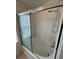 Modern bathroom with a tub and shower featuring sliding glass doors and tile surround, perfect for relaxation at 1984 Estancia Circle # 29A, Kissimmee, FL 34741