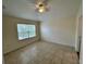 Bright bedroom featuring tile floors, ceiling fan, and a view to the outside at 1984 Estancia Circle # 29A, Kissimmee, FL 34741