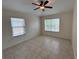 Bright bedroom with tiled floors, two windows, and a ceiling fan, providing a comfortable and airy atmosphere at 1984 Estancia Circle # 29A, Kissimmee, FL 34741