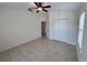 Spacious bedroom featuring tiled floors, a ceiling fan, and a closet, offering a versatile living space at 1984 Estancia Circle # 29A, Kissimmee, FL 34741