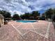 A sparkling community pool with clear blue water, surrounded by lounge chairs and a brick patio at 1984 Estancia Circle # 29A, Kissimmee, FL 34741