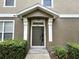 Inviting front door with decorative columns framed by lush greenery at 1984 Estancia Circle # 29A, Kissimmee, FL 34741