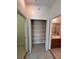 Hallway closet with shelving providing generous storage space, along with hallway bathroom at 1984 Estancia Circle # 29A, Kissimmee, FL 34741