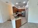 Cozy kitchen with wood cabinets, stainless steel appliances, and a breakfast bar at 1984 Estancia Circle # 29A, Kissimmee, FL 34741