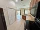 Open kitchen view with backyard access through sliding glass doors and a pantry at 1984 Estancia Circle # 29A, Kissimmee, FL 34741