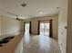 Spacious, tiled living area with ceiling fan and natural light from sliding glass doors at 1984 Estancia Circle # 29A, Kissimmee, FL 34741