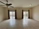 Expansive living area featuring tile flooring, ceiling fan, and slider glass doors at 1984 Estancia Circle # 29A, Kissimmee, FL 34741