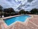 Bright community pool with brick pavers, metal fence, and plenty of room for lounge chairs at 1984 Estancia Circle # 29A, Kissimmee, FL 34741