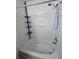 Clean white shower and tub combination with a convenient corner shelf and updated shower head at 1984 Estancia Circle # 29A, Kissimmee, FL 34741