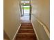 Staircase featuring a safety railing and wooden steps leading to a front door with window at 1984 Estancia Circle # 29A, Kissimmee, FL 34741