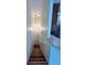 Carpeted staircase leading downstairs with a chandelier and a half wall looking into the kitchen at 1984 Estancia Circle # 29A, Kissimmee, FL 34741