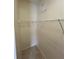 Compact walk-in closet equipped with wire shelving, maximizing storage capacity in a small space at 1984 Estancia Circle # 29A, Kissimmee, FL 34741