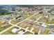 Suburban homes in a planned community featuring green spaces, ponds, and manicured lawns at 205 Cimarron Dr, Kissimmee, FL 34759
