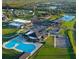 Aerial view of a community with pool, clubhouse, gym, and surrounding residential area at 205 Cimarron Dr, Kissimmee, FL 34759