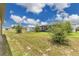 Large backyard features a shed with ample grassy space for outdoor activities, plus a view of neighboring houses at 205 Cimarron Dr, Kissimmee, FL 34759
