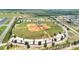 Aerial view of community baseball field surrounded by lush greenery and trees at 205 Cimarron Dr, Kissimmee, FL 34759