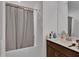 This bathroom offers a shower-tub combo, sleek vanity, and a well-lit mirror, with plenty of countertop space at 205 Cimarron Dr, Kissimmee, FL 34759