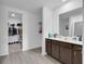 This bathroom boasts wood floors, double vanity, and provides entry to a walk-in closet for optimal storage at 205 Cimarron Dr, Kissimmee, FL 34759