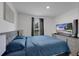 Comfortable bedroom with gray headboard, complementary dresser, and flat screen TV for relaxing evenings at 205 Cimarron Dr, Kissimmee, FL 34759