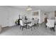 Elegant dining room featuring a modern chandelier and a glass-top table with seating for six at 205 Cimarron Dr, Kissimmee, FL 34759