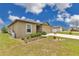 Inviting single-story home with landscaped yard and spacious driveway at 205 Cimarron Dr, Kissimmee, FL 34759