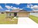 Charming home with a well-manicured lawn and a two-car garage at 205 Cimarron Dr, Kissimmee, FL 34759