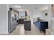 Open-concept kitchen with stainless steel appliances, island, and wood-look flooring at 205 Cimarron Dr, Kissimmee, FL 34759