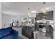 Modern kitchen with an island, stainless steel appliances, and an adjacent dining area at 205 Cimarron Dr, Kissimmee, FL 34759