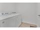 Convenient laundry room features side-by-side washer and dryer for efficient chore management at 205 Cimarron Dr, Kissimmee, FL 34759