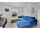 Cozy living room with a plush blue sofa and bright natural light at 205 Cimarron Dr, Kissimmee, FL 34759