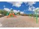 A bright and cheerful community playground with slides, swings, and climbing structures under a sunny sky at 205 Cimarron Dr, Kissimmee, FL 34759