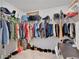 Organized walk-in closet features ample storage with extensive hanging racks and shoe shelves for easy organization at 205 Cimarron Dr, Kissimmee, FL 34759