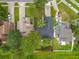 Aerial view of several homes with driveways and mature trees in a well-maintained neighborhood at 2160 Churchill Downs Cir, Orlando, FL 32825