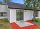 Backyard featuring a door leading to a patio area at 2160 Churchill Downs Cir, Orlando, FL 32825