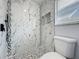 Modern bathroom with a walk-in shower featuring decorative tile and black shower fixtures at 2160 Churchill Downs Cir, Orlando, FL 32825