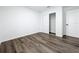 Empty bedroom with wood-look floors, closet, and white doors at 2160 Churchill Downs Cir, Orlando, FL 32825