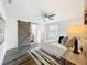 Bedroom with gray-toned wood floors, a ceiling fan, and a sliding barn door to the bathroom at 2160 Churchill Downs Cir, Orlando, FL 32825