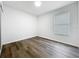 A bright, empty bedroom with hardwood-style flooring and a window at 2160 Churchill Downs Cir, Orlando, FL 32825