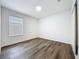 A bright, empty bedroom with hardwood-style flooring and a window at 2160 Churchill Downs Cir, Orlando, FL 32825