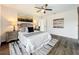 Bright bedroom featuring neutral decor, dark wood-look flooring, and stylish lighting at 2160 Churchill Downs Cir, Orlando, FL 32825