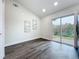 Well-lit room with gray wood-look floors and sliding glass door to a patio at 2160 Churchill Downs Cir, Orlando, FL 32825