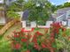 Aerial view of the back of the home and backyard with a privacy fence and blooming Crepe Myrtle at 2160 Churchill Downs Cir, Orlando, FL 32825