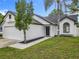 A lovely one-story home features a manicured lawn, well maintained landscaping, and charming curb appeal at 2160 Churchill Downs Cir, Orlando, FL 32825